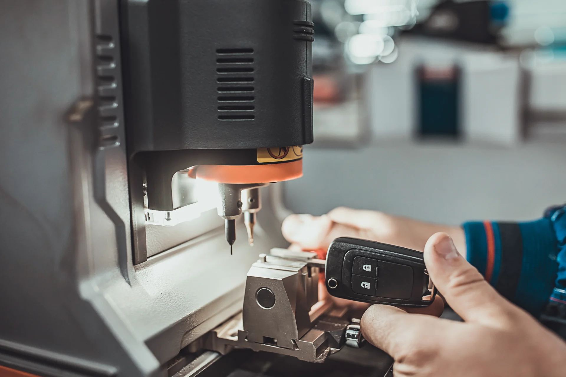 Car key being duplicated with machine.
