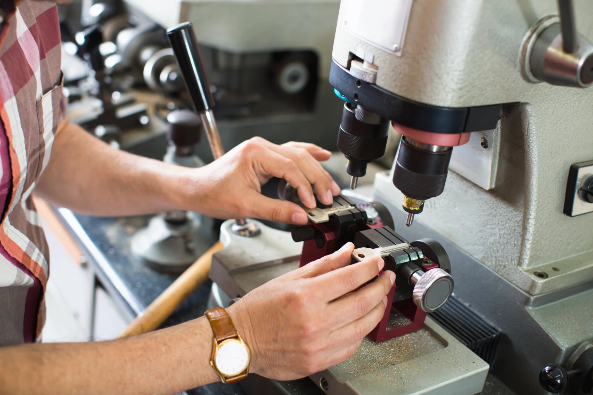 Person operating a metalworking machine in workshop.