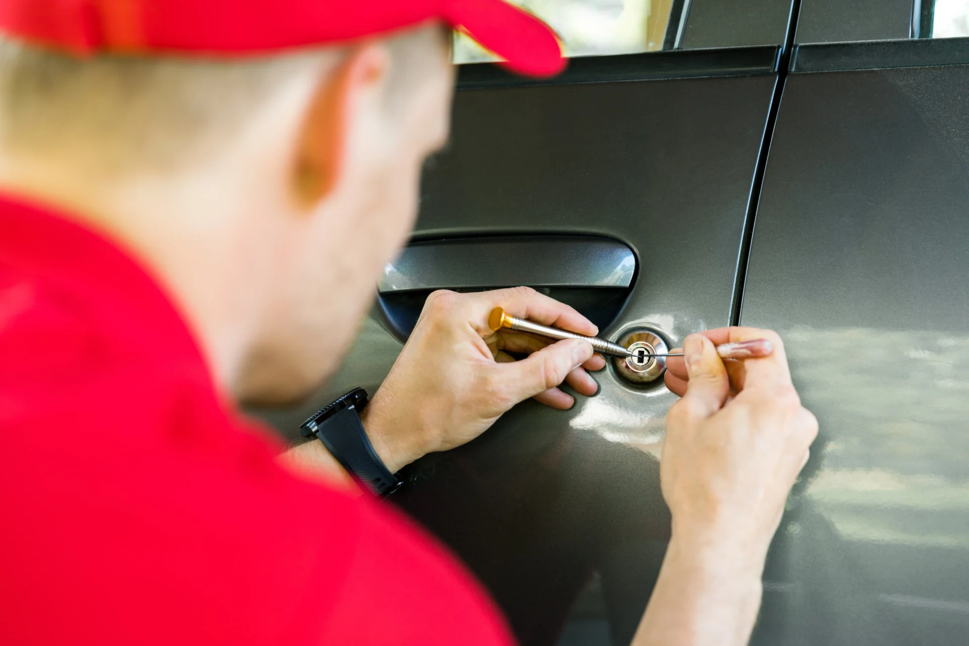 Professional emergency locksmith picking a car door lock in Brooklyn, NY.
